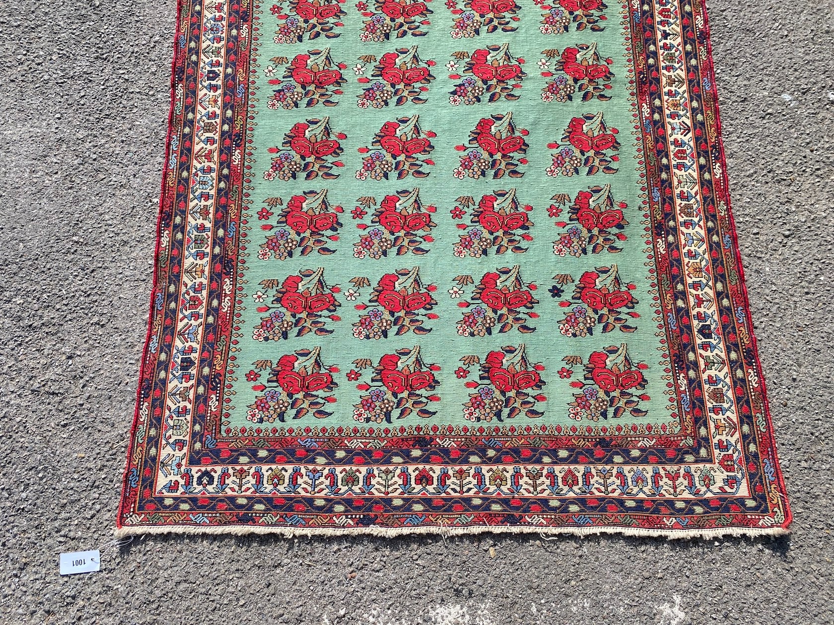 A Kirman Shah rug woven with floral bunches on a green ground within a conforming multi border 184cm X 120cm